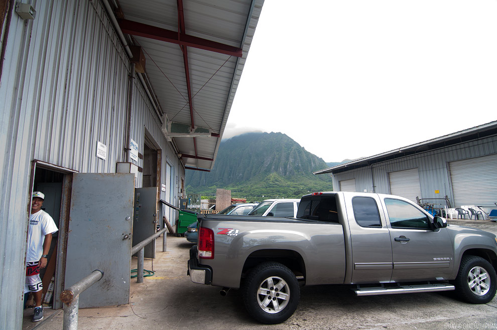 Photo of Hawaii surfboard shaper Jason Kashiwai in front of his shop.