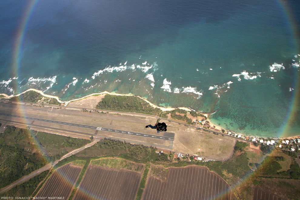 T. K. Hinshaw skydives through a circular rainbow in Hawaii