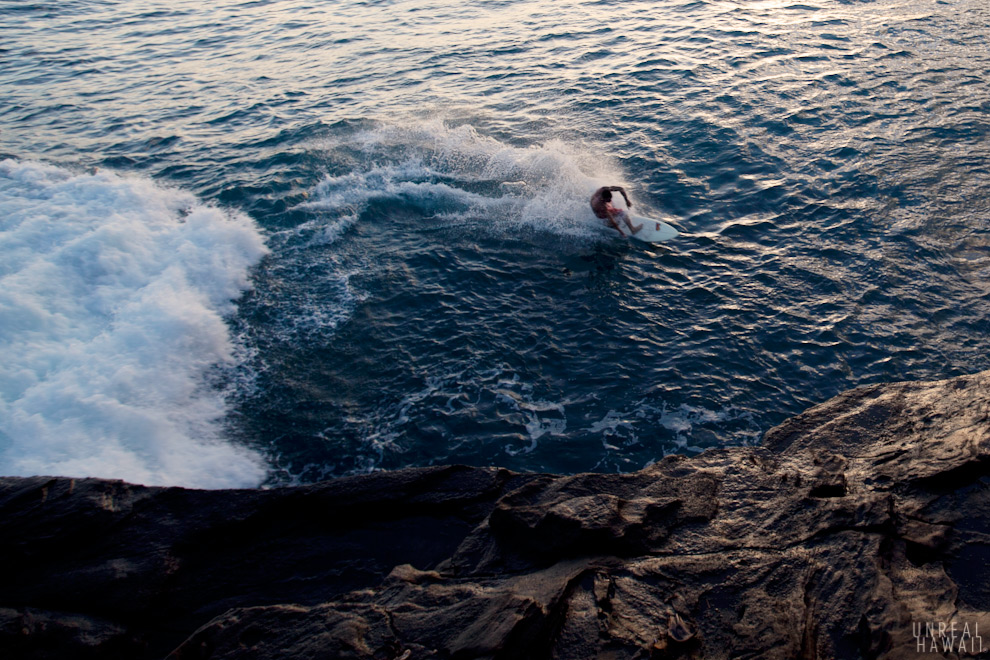 A surfer cutting back at China Walls, Oahu, Hawaii