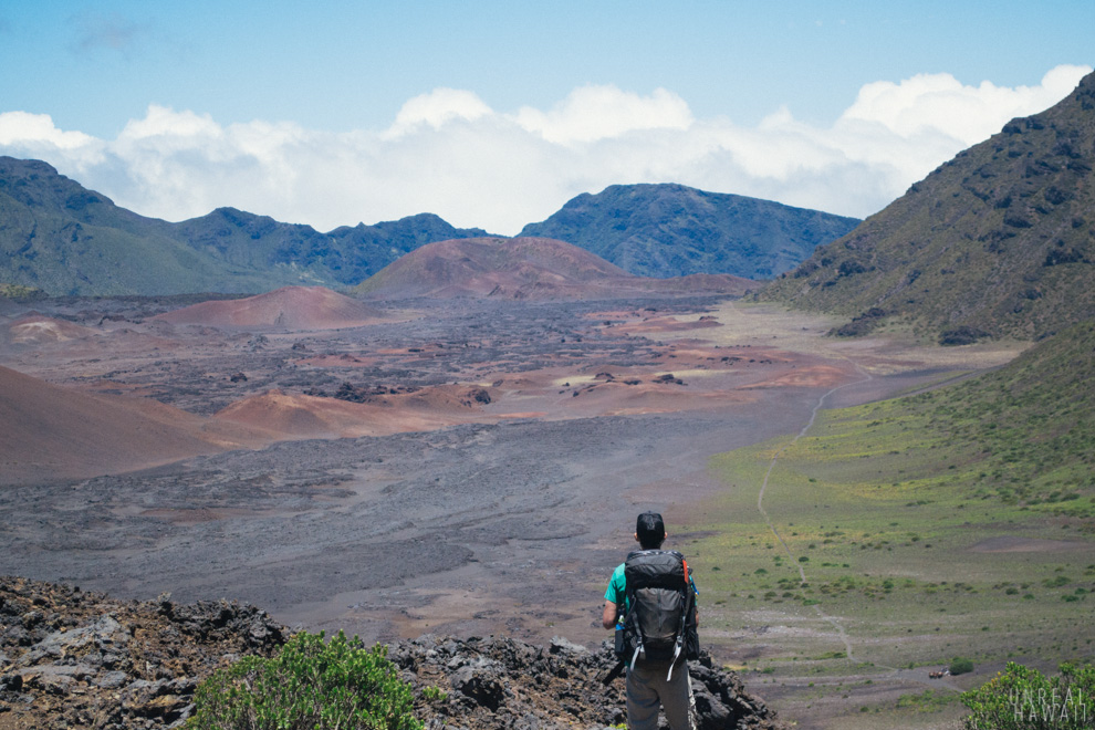 A backpackers looks out over Haleakala crater.