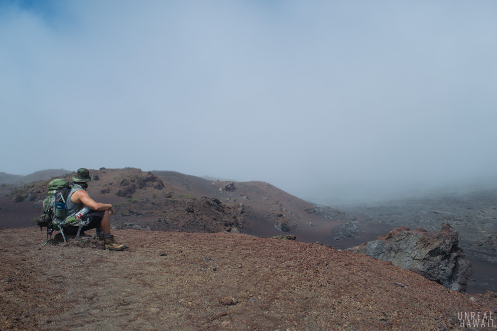 Taking a rest while backpacking Haleakala. A hike in Maui, Hawaii.