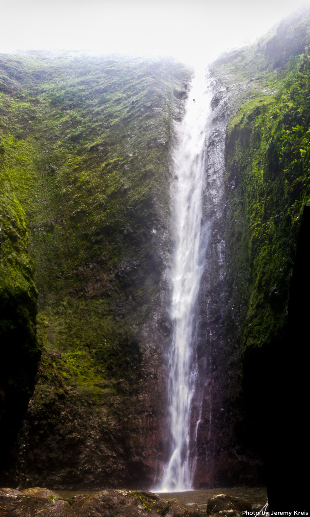 Kitt Turner rappelling down a 500 ft waterfall on Oahu.
