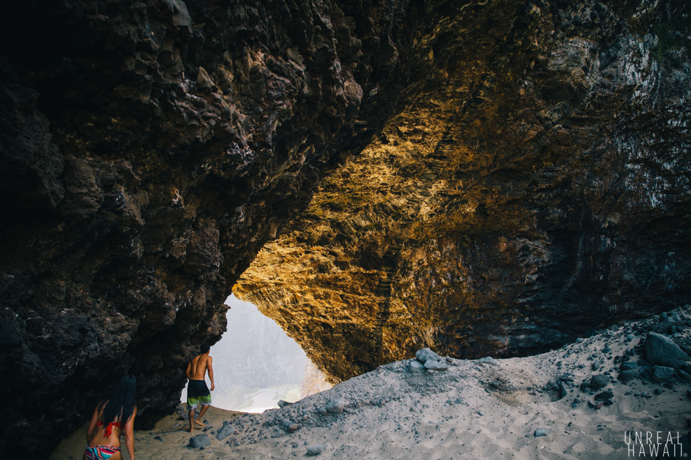 Walking through the Honopu Beach Arch, Kauai, Hawaii